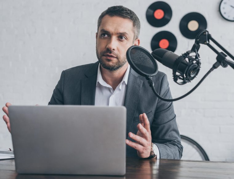 handsome-radio-host-gesturing-while-speaking-in-mi-2021-09-15-00-45-32-utc.jpg